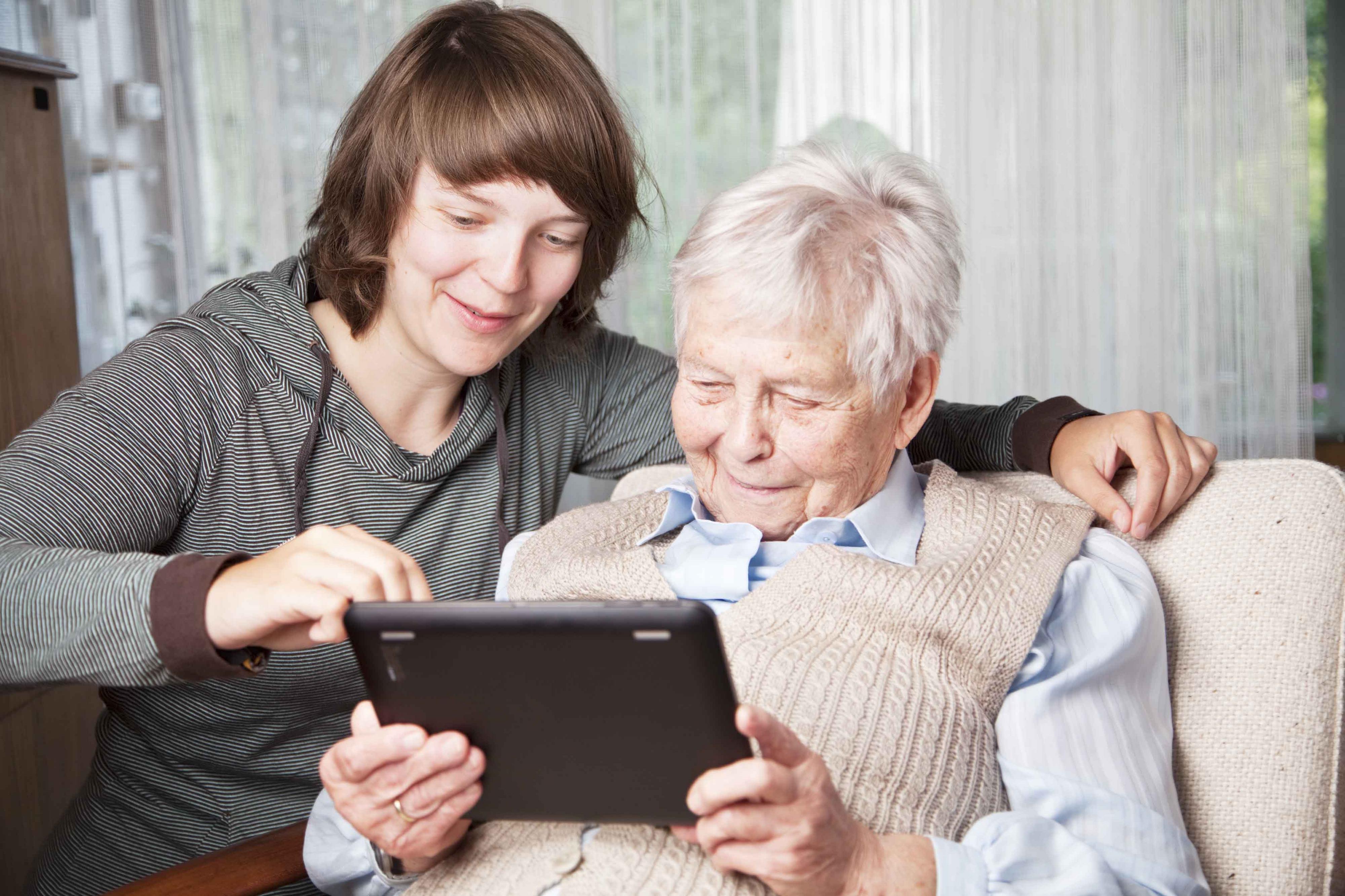 young woman and senior woman using digital tablet.